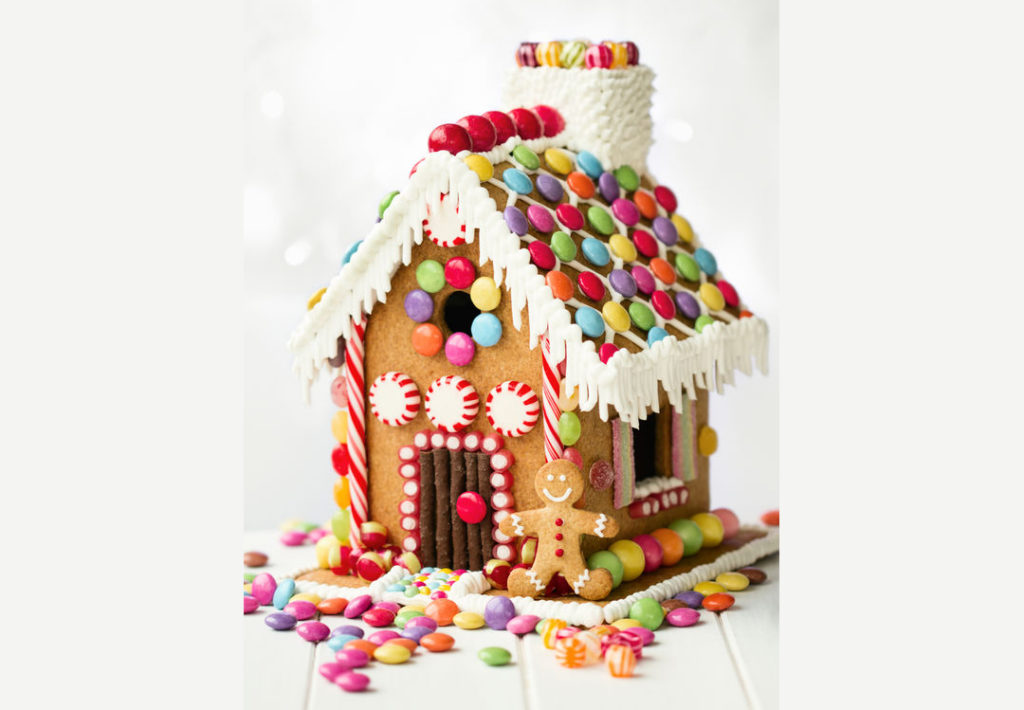 47120345 – gingerbread house decorated with colorful candies