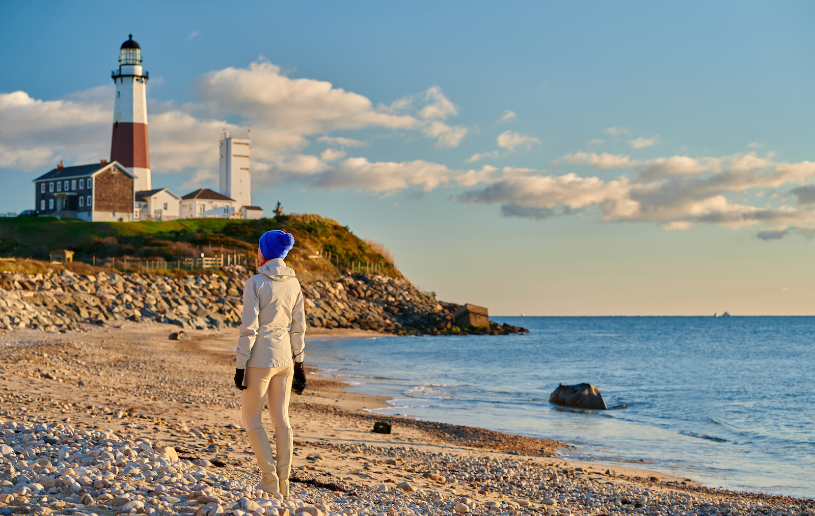 Woman tourist at the beach near Montauk Lighthouse