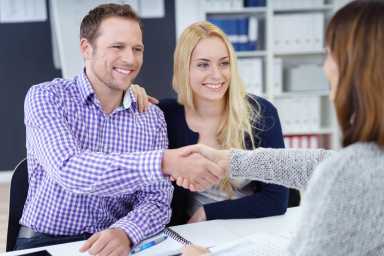 Smiling pleased couple shaking hands