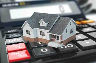 Mortgage calculator. House on buttons. Real estate concept.