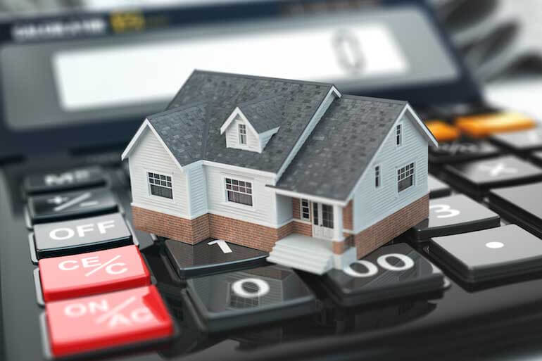 Mortgage calculator. House on buttons. Real estate concept.