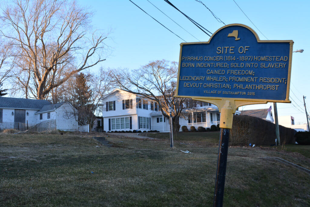 The historical marker at 51 Pond Lane, where all that remains of the Pyrrhus Concer Homestead is the worn-down pool house (far left)