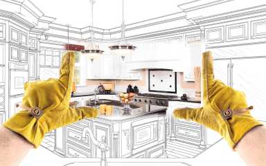 Male Contractor Hands Framing Completed Section of Custom Kitchen Design Drawing.