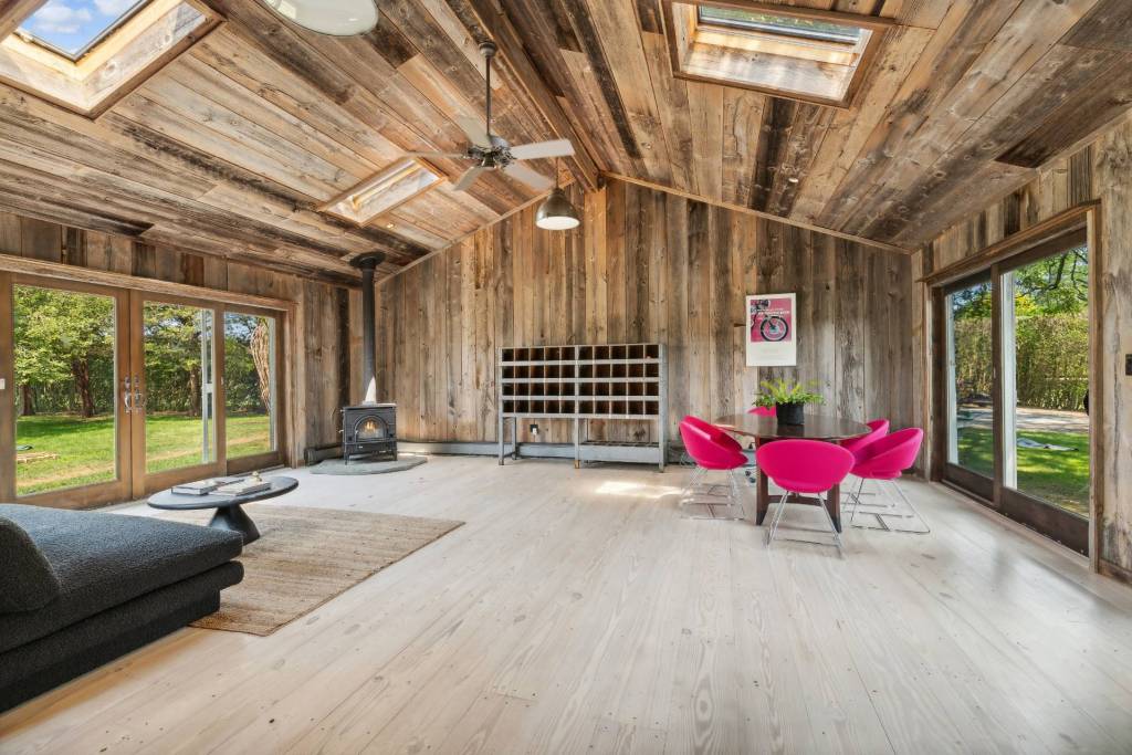 Wood serves as a primary material featured throughout the home, creating a country appeal and barn-like feel.