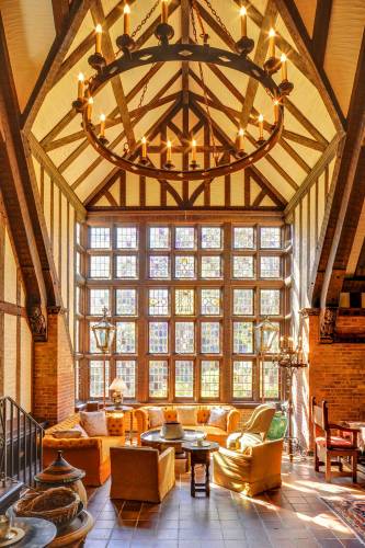 The library creates space for quiet and relaxation with a high ceiling and a wall of natural light through windows.