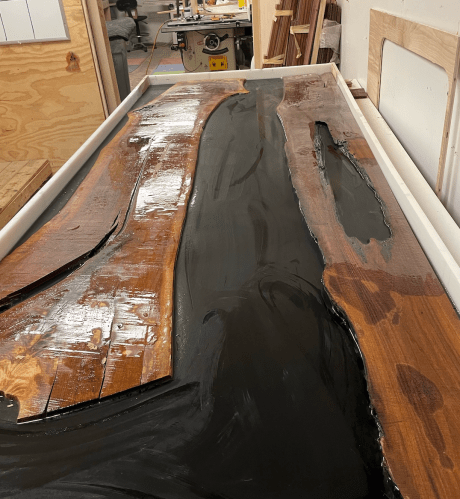 Custom “epoxy river” dining tables — one of the couple’s specialties.