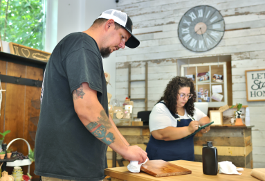 Jason and Samantha Nagorski at work in their Wading River shop.